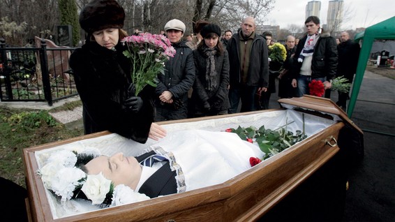 Nataliya Magnitskaya (left) grieves over the body of her son, Sergei Magnitsky, at his funeral at a Moscow cemetery on November 20 2009